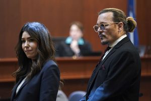 US actor Johnny Depp stands next to his lawyer Camille Vasquez after a break in the defamation trial against ex-wife Amber Heard at the Fairfax County Circuit Courthouse in Fairfax, Virginia, on May 18, 2022. - Depp is suing ex-wife Amber Heard for libel after she wrote an op-ed piece in The Washington Post in 2018 referring to herself as a �public figure representing domestic abuse.� (Photo by KEVIN LAMARQUE / POOL / AFP)