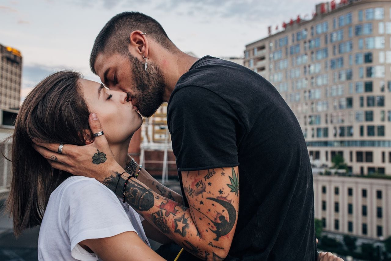 Young urban couple kissing passionately
