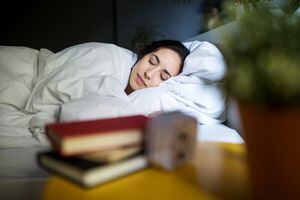 Young woman sleeping peacefully on her bed at home