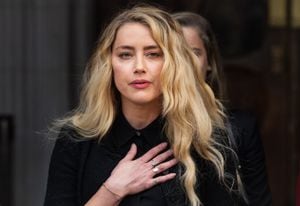 LONDON, ENGLAND - JULY 28: Amber Heard reads a statement after the trial at  the Royal Courts of Justice, Strand on July 28, 2020 in London, England. Hollywood Actor Johnny Depp is suing News Group Newspapers (NGN) and the Sun's executive editor, Dan Wootton, over an article published in 2018 that referred to him as a "wife beater" during his marriage to actor Amber Heard. (Photo by Samir Hussein/WireImage)