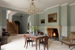 White painted panelled reception room of Gloucestershire country estate