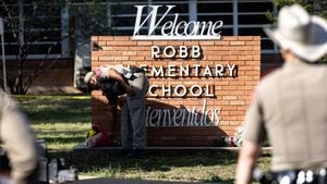 UVALDE, TX - MAY 25: A Texas State Trooper receives flowers for the victims of a mass shooting yesterday at Robb Elementary School where 21 people were killed, including 19 children, on May 25, 2022 in Uvalde, Texas. The shooter, identified as 18-year-old Salvador Ramos, was reportedly killed by law enforcement. (Photo by Jordan Vonderhaar/Getty Images)