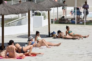 MADRID, SPAIN - MAY 14: Several people sunbathe at the Casa de Campo municipal swimming pool on May 14, 2022, in Madrid, Spain. Today, May 14, the municipal swimming pools of the Community of Madrid open, with free access as it is the first day of opening, and will remain open until September 12. As last year, two shifts of use are maintained, closing at noon from 14.30 to 16.30 hours, to disinfect and clean the facilities, a measure that was adopted for the first time in the sports facilities last year due to the pandemic. (Photo By Gustavo Valiente/Europa Press via Getty Images)
