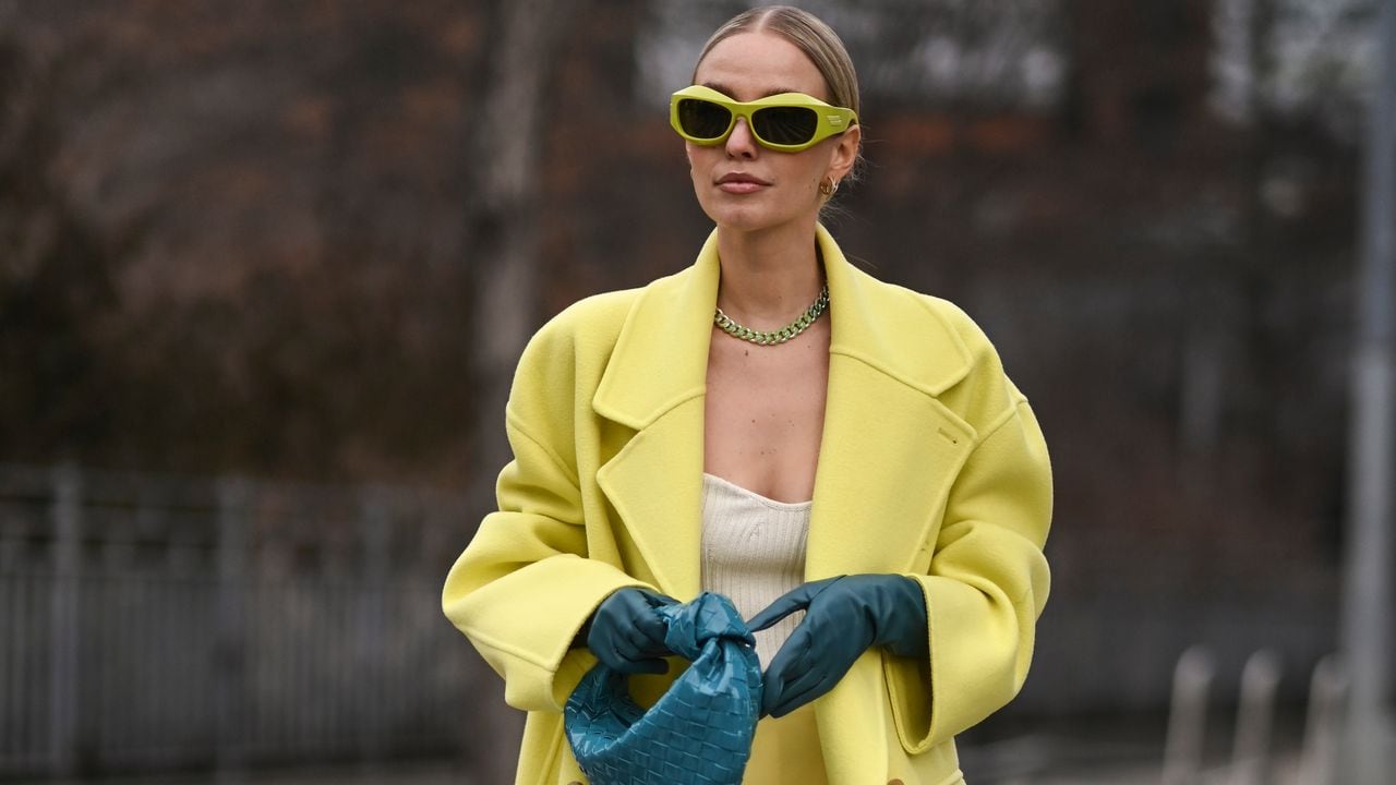 NEW YORK, NEW YORK - FEBRUARY 16: Leonie Hanne is seen wearing a yellow Prabal Gurung coat, skirt and blue gloves with a blue purse and lime green sunglasses outside the Prabal Gurung show during New York Fashion Week A/W 2022 on February 16, 2022 in New York City. (Photo by Daniel Zuchnik/Getty Images)