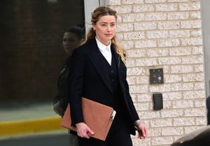 FAIRFAX, VA - APRIL 21:(NY & NJ NEWSPAPERS OUT) Amber Heard departs following the recess for the day outside court during the Johnny Depp and Amber Heard civil trial at Fairfax County Circuit Court on April 21, 2022 in Fairfax, Virginia. Depp is seeking $50 million in alleged damages to his career over an op-ed Heard wrote in the Washington Post in 2018.(Photo by Ron Sachs/Consolidated News Pictures/Getty Images)