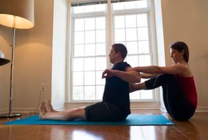 FAIRFAX, VIRGINIA - March 8: Former  U.S. Marine Captain, Billy Birdzell, left, does yoga with his girlfriend Meaghan Kennedy Townsend at their home in Fairfax, Virginia on March 8, 2014. Birdzell, spent 8 years in the Marines and  currently works at the NRA, said he discovered that his cortisol levels were at least partly to blame for the symptoms the VA was calling PTSD. Yoga is one way he deals with wellness. (Photo by Michel du Cille/The Washington Post via Getty Images)