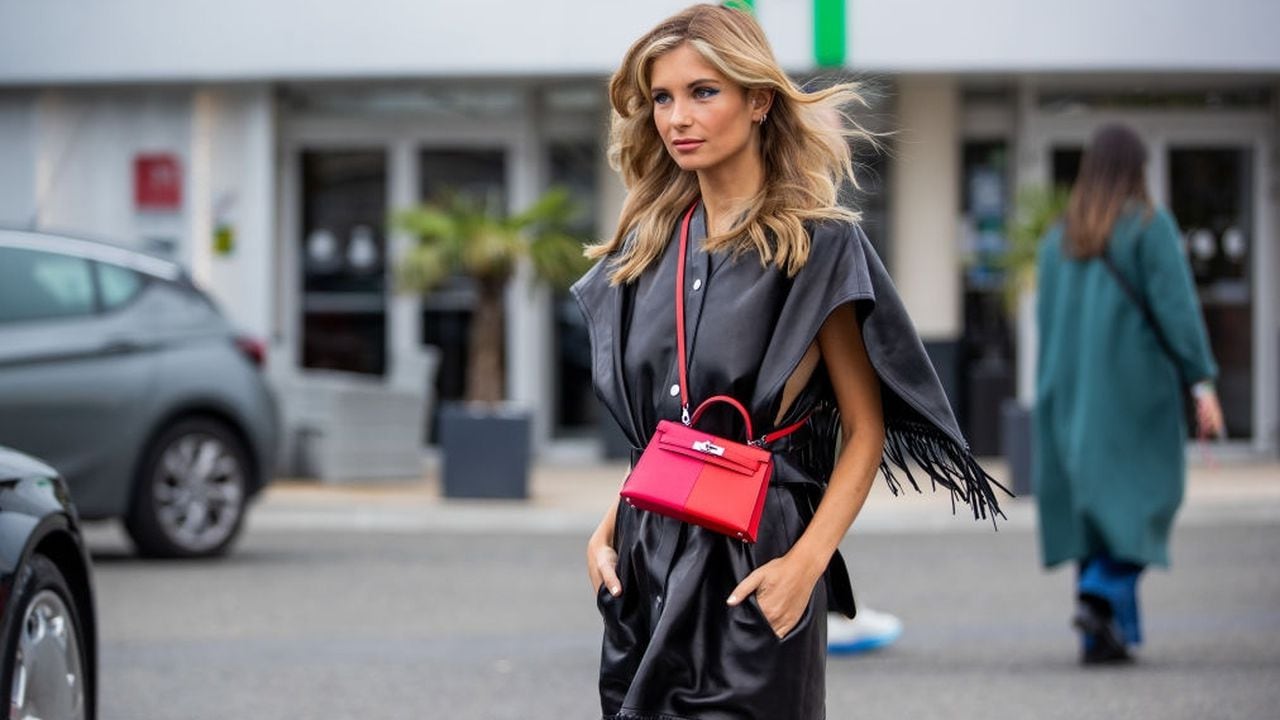 PARIS, FRANCE - OCTOBER 02: Xenia Adonts seen wearing red Hermes bag, black cape with fringes, black boots outside Hermes during Paris Fashion Week - Womenswear Spring Summer 2022 on October 02, 2021 in Paris, France. (Photo by Christian Vierig/Getty Images)