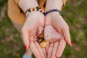Young woman holding crystals in her arms in the park.