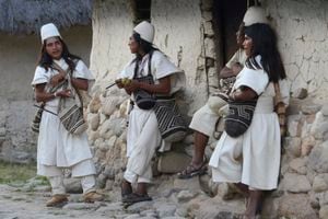 NABUSIMAKE, COLOMBIA - JANUARY 23, 2015: Typically dressed Arhuaco men stand outside a hut in the walled village (Pueblito) on January 23, 2015 Nabusimake, Colombia. The Arhuacos appear in white serapes, and carry beautifully stitched handbags (Mochilas) slung across lean shoulders. Nabusimake is the spiritual center of the Arhuaco indigenous people and the place where they say the sun was born. Located high in the Sierra Nevada mountains, the community and their way of living inspire a spiritual stillness and the surrounding area is alive with virgin forests, waterfalls, and birds. (Photo by Kaveh Kazemi/Getty Images)