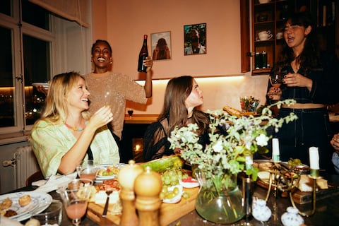 Carefree female friends enjoying together at dinner party