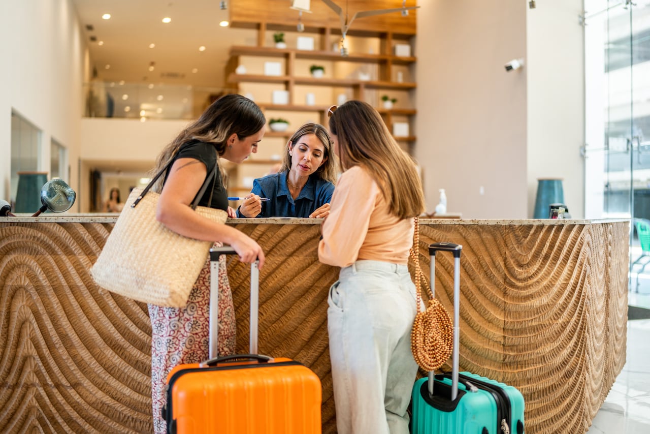 Hotel receptionist talking customers at lobby