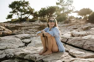 Happy woman enjoying in beautiful sunny day on a beach