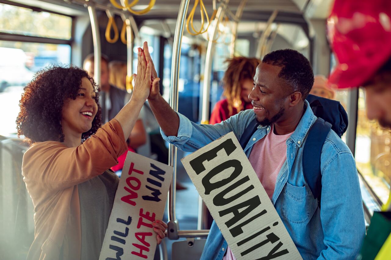 Close up of two friends on a bus going to a protest