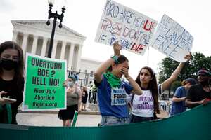 WASHINGTON, DC - JUNE 24: Abortion-rights activists Carrie McDonald (C) and Soraya Bata react to the Dobbs v Jackson Women's Health Organization ruling in front of the U.S. Supreme Court on June 24, 2022 in Washington, DC. The Court's decision in Dobbs v Jackson Women's Health overturns the landmark 50-year-old Roe v Wade case and erases a federal right to an abortion. (Photo by Anna Moneymaker/Getty Images)
