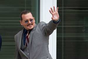 FAIRFAX, VA - May 16: (NY & NJ NEWSPAPERS OUT) Johnny Depp waves to fans during a break outside court during the Johnny Depp and Amber Heard civil trial at Fairfax County Circuit Court on May 16, 2022 in Fairfax, Virginia. Depp is seeking $50 million in alleged damages to his career over an op-ed Heard wrote in the Washington Post in 2018.(Photo by Cliff Owen/Consolidated News Pictures/Getty Images)