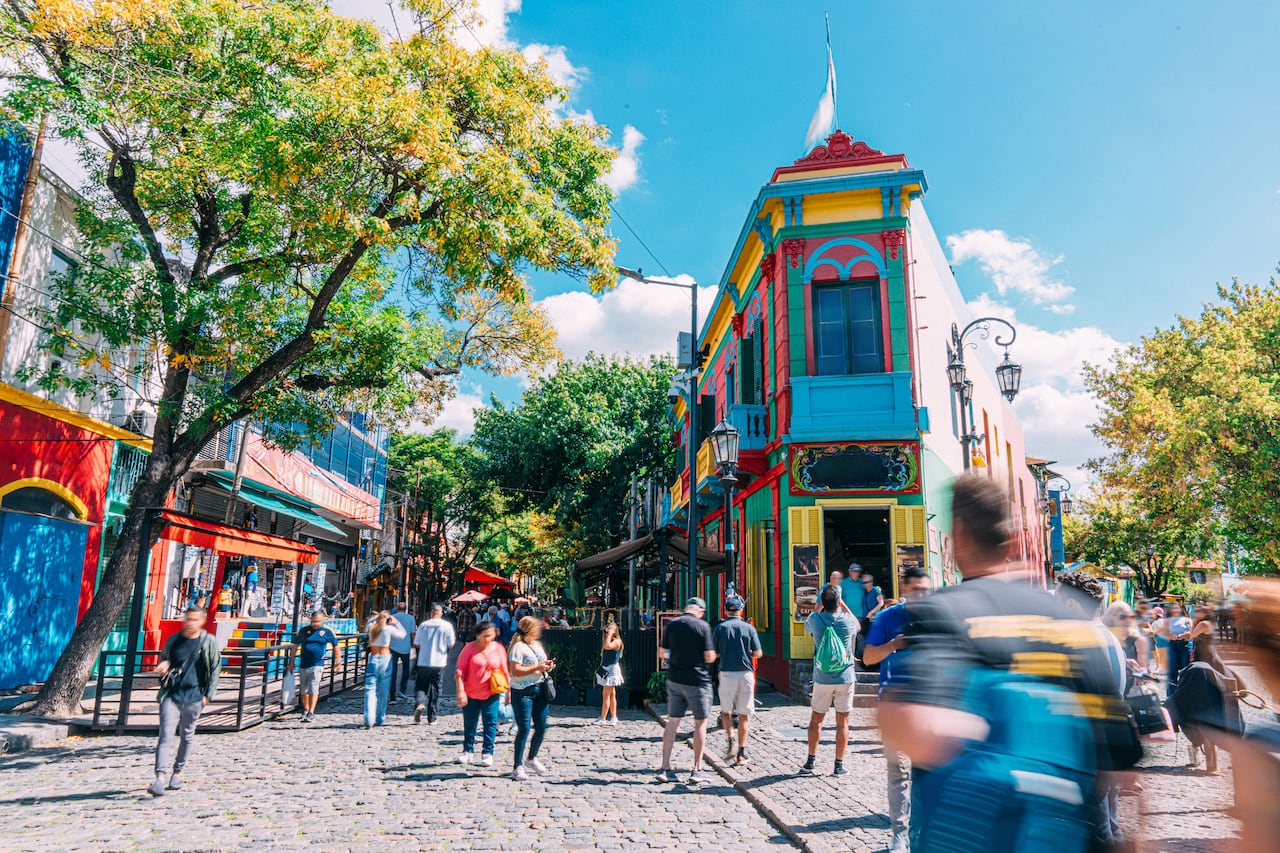 A Wide Angle View of Tourists visiting the Vibrant-Colored Houses and Businesses in La Boca, Buenos Aires, Argentina.
Many ship-building residents built homes from leftover ship materials and paint, creating mismatched textures and patchwork style.