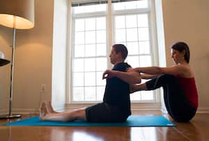 FAIRFAX, VIRGINIA - March 8: Former U.S. Marine Captain, Billy Birdzell, left, does yoga with his girlfriend Meaghan Kennedy Townsend at their home in Fairfax, Virginia on March 8, 2014. Birdzell, spent 8 years in the Marines and currently works at the NRA, said he discovered that his cortisol levels were at least partly to blame for the symptoms the VA was calling PTSD. Yoga is one way he deals with wellness. (Photo by Michel du Cille/The Washington Post via Getty Images)
