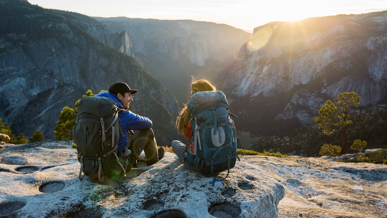 A couple backpacking in the mountains.