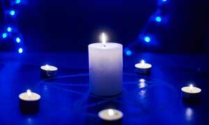 Pentagram and burning candles. The magical ritual of Satanism, invocation of spirits, spiritualistic sessions.