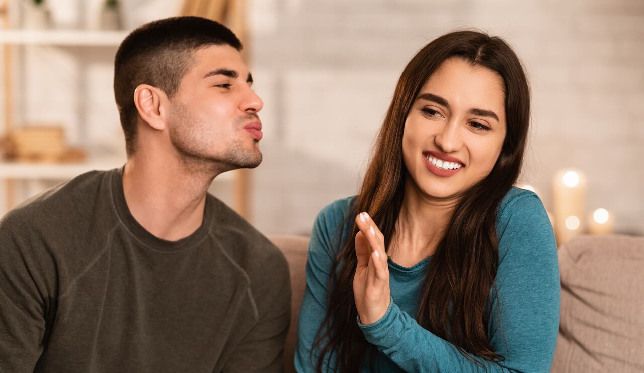 Bad Breath Concept. Girl ignoring and rejecting boy who trying to kiss her