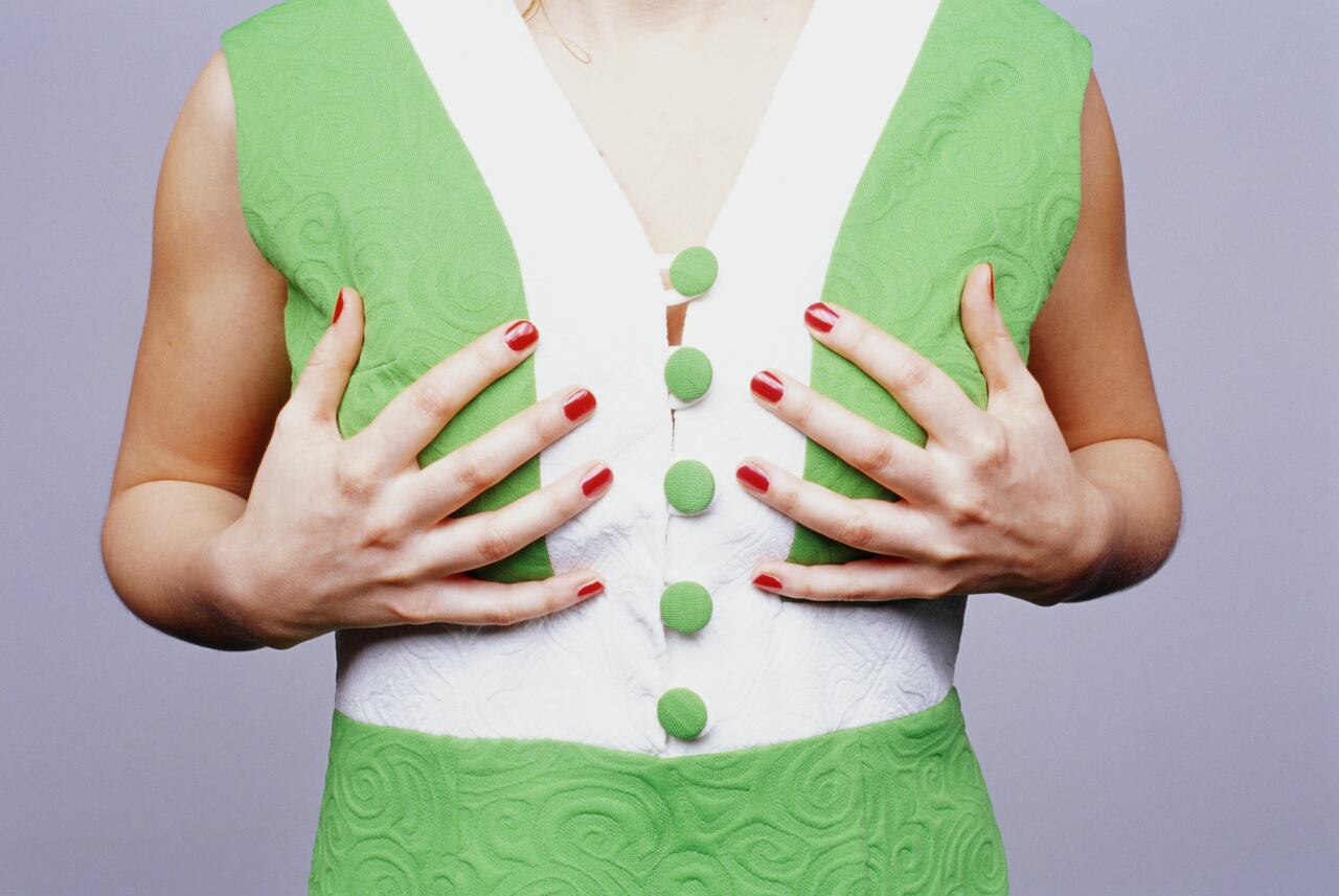 Woman touching her breast