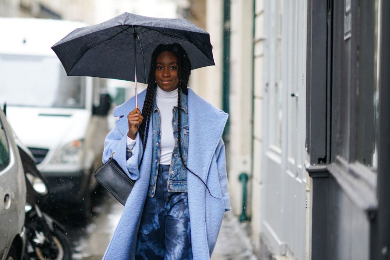 PARIS, FRANCE - MARCH 01: A guest wears a blue wool coat, a white turtleneck pullover, a blue denim jacket, blue pants, a bag, during Paris Fashion Week - Womenswear Fall/Winter 2020/2021, on March 01, 2020 in Paris, France. (Photo by Edward Berthelot/Getty Images)
