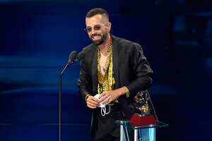 Mike Bahia accepts the award for best new artist at the 21st Latin Grammy Awards, airing on Thursday, Nov. 19, 2020, at American Airlines Arena in Miami. (AP Photo/Marta Lavandier)