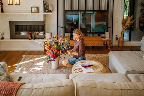 Florist woman during pregnancy arranges flowers to enhance her living space and organizes her surroundings