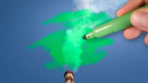Man painting green pollution from a chimney. greenwashing malpractice concept