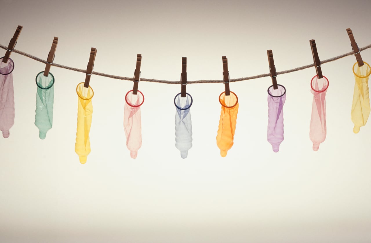 Condoms hanging on pegs from line