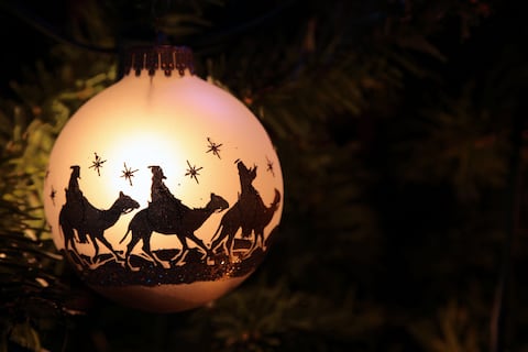Christmas ornament with silhouettes of the 3 wise men on their camels. Room for copy space. Horizontal image would be good for Christian or religious Christmas use.