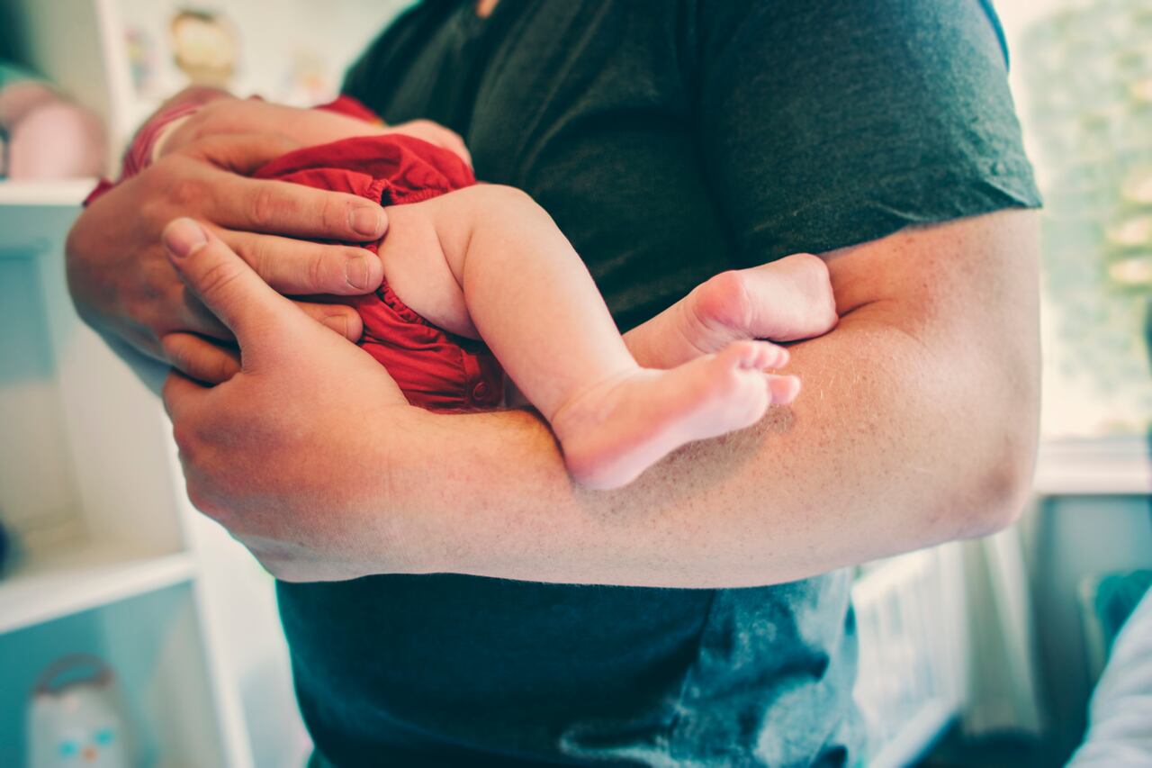 Father holding his newborn baby girl