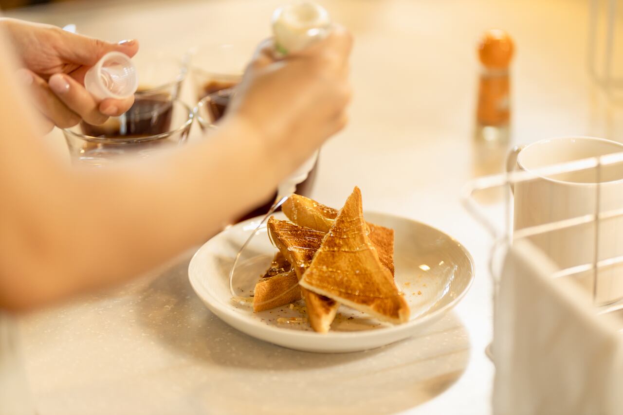 A woman preparing a tasty maple toast snack.