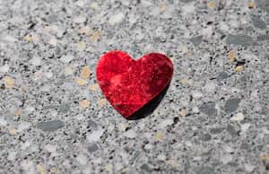 23 February 2022, Lower Saxony, Hanover: A red shiny heart lies on a downtown sidewalk. Photo: Julian Stratenschulte/dpa (Photo by Julian Stratenschulte/picture alliance via Getty Images)