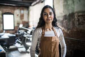 Portrait of female business owner in printing shop