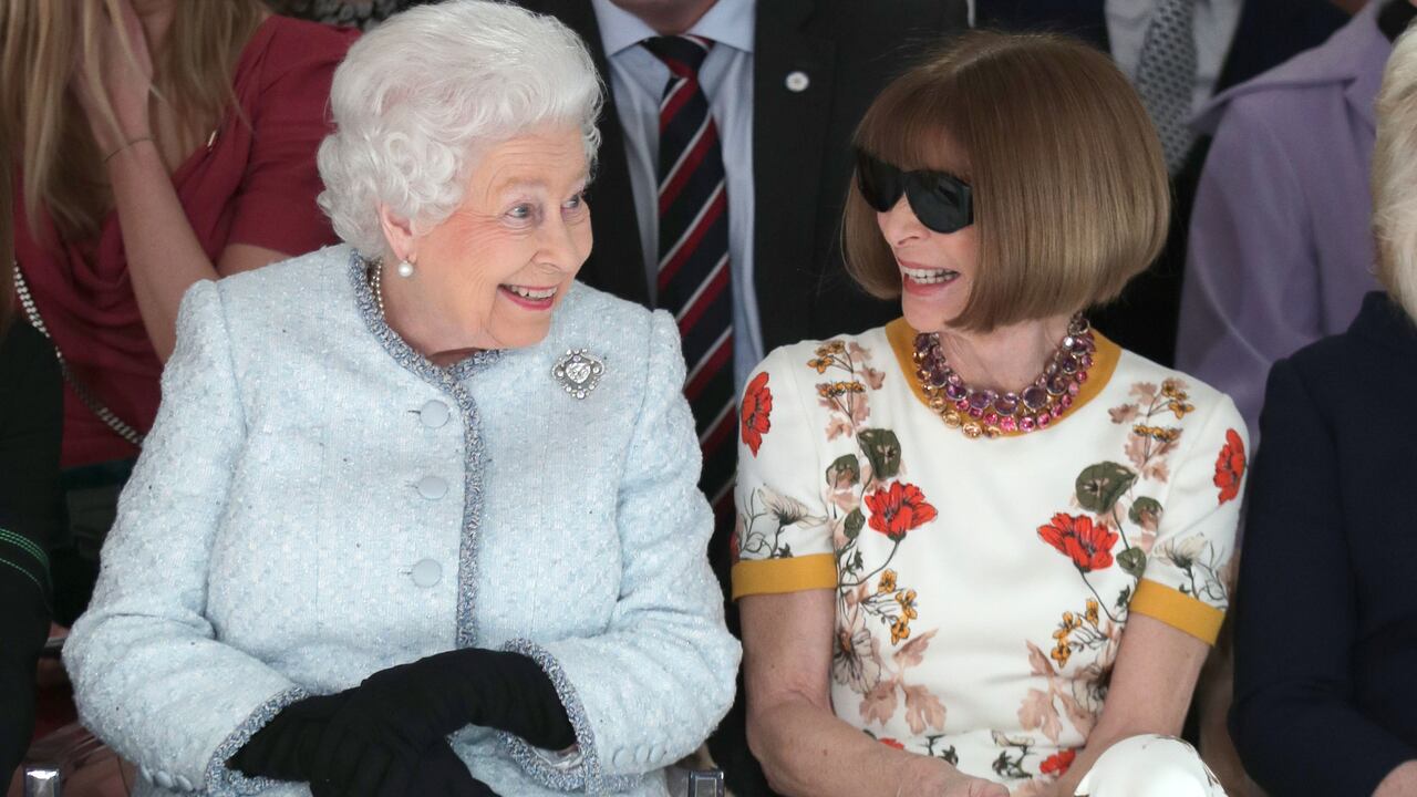 LONDON, ENGLAND - FEBRUARY 20: Queen Elizabeth II sits next to Anna Wintour as they view Richard Quinn's runway show before presenting him with the inaugural Queen Elizabeth II Award for British Design as she visits London Fashion Week's BFC Show Space on February 20, 2018 in London, United Kingdom. (Photo by Yui Mok - Pool/Getty Images)