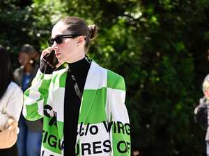 NEW YORK, NEW YORK - SEPTEMBER 08: A guest is seen wearing a green and white Off-White jacket, black dress, black and silver Off-White bag and green Nike sneakers outside the Off-White show during NYFW Spring/Summer 2025 on September 08, 2024 in New York City. (Photo by Daniel Zuchnik/Getty Images)