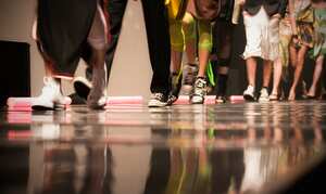 Fashion show with models on stage.