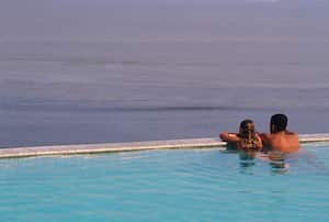 Couple observes one of hundreds of rivers in the Amazon relaxing on a jungle hotel