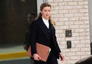 FAIRFAX, VA - APRIL 21:(NY & NJ NEWSPAPERS OUT) Amber Heard departs following the recess for the day outside court during the Johnny Depp and Amber Heard civil trial at Fairfax County Circuit Court on April 21, 2022 in Fairfax, Virginia. Depp is seeking $50 million in alleged damages to his career over an op-ed Heard wrote in the Washington Post in 2018.(Photo by Ron Sachs/Consolidated News Pictures/Getty Images)