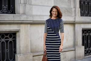 Portrait of smiling businesswoman standing against building