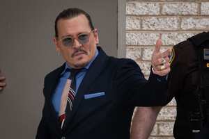 FAIRFAX, VA - MAY 5: (NY & NJ NEWSPAPERS OUT) Johnny Depp gestures to his fans during the afternoon recess outside court during the Johnny Depp and Amber Heard civil trial at Fairfax County Circuit Court on May 5, 2022 in Fairfax, Virginia. Depp is seeking $50 million in alleged damages to his career over an op-ed Heard wrote in the Washington Post in 2018.(Photo by Cliff Owen/Consolidated News Pictures/Getty Images)
