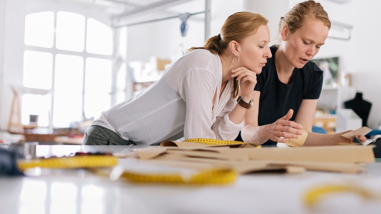 Fashion designers working with fabric and sewing