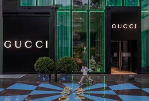 BEIJING, CHINA - MAY 10: A boy runs by a closed store of the luxury brand Gucci at Taikoo Li mall in Sanlitun after many retail stores were closed to help prevent the spread of COVID-19 on May 10, 2022 in Beijing, China. China is trying to contain a spike in coronavirus cases in the capital Beijing after hundreds of people tested positive for the virus in recent weeks, causing local authorities to initiate mass testing in most districts, close schools and stores, ban gatherings and inside dining in all restaurants, and to lockdown some neighbourhoods in an effort to maintain the country's zero COVID strategy.(Photo by Kevin Frayer/Getty Images)